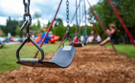 An empty swing on a swingset