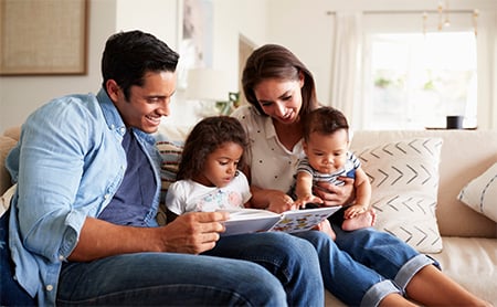 A family reads together on the couch