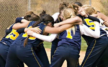 Young girls in team huddle