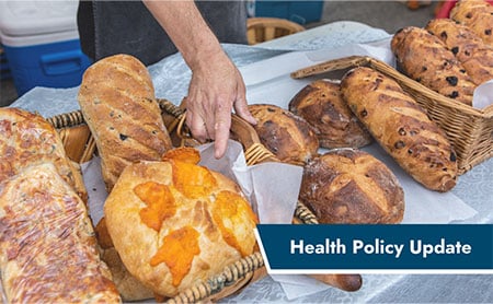 HPU-hand-pointing-to-bread-on-table-full-of-different-breads.jpg