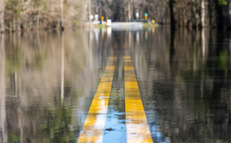 A submerged road under water after a natural disaster.