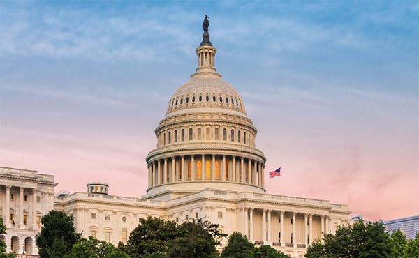 U.S. Capitol dome and buildings from the west at sunrise